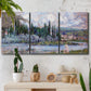 Three-panel canvas wall art featuring summer village view along river, displayed in a boho-chic entryway above a console table.
