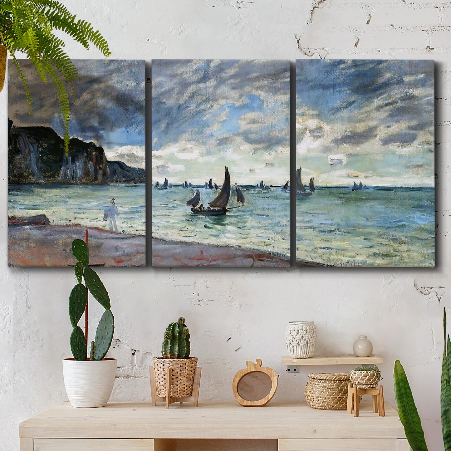 Three-panel canvas wall art featuring figures walking along sandy shoreline, displayed in a boho-chic entryway above a console table.