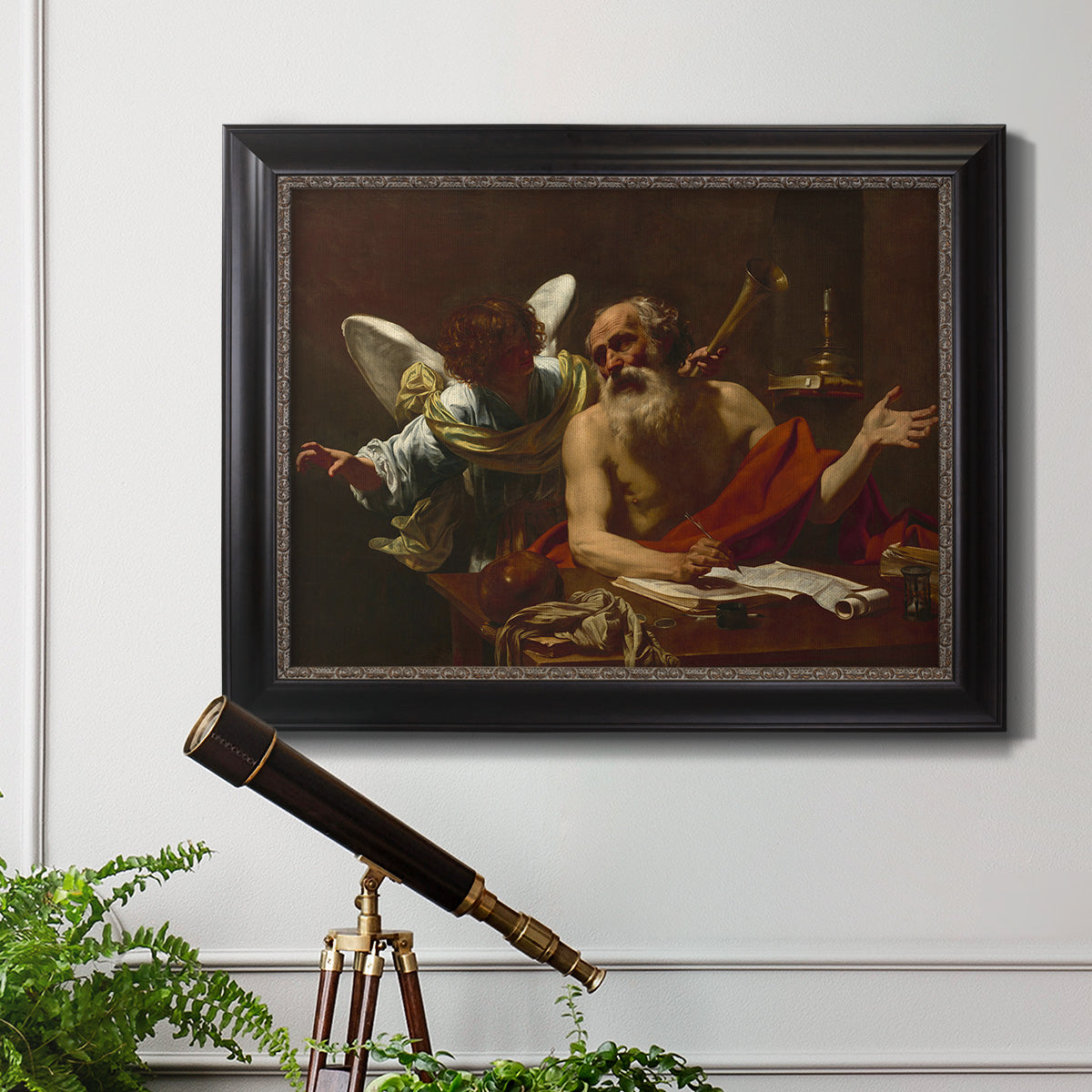 Classical religious painting of Saint Jerome with an angel by Simon Vouet in an ornate black frame with gilded inner detail displayed in a light-toned interior setting.