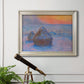 Impressionist haystack scene at sunset by Claude Monet in an ornate champagne frame displayed in a light-toned interior setting.