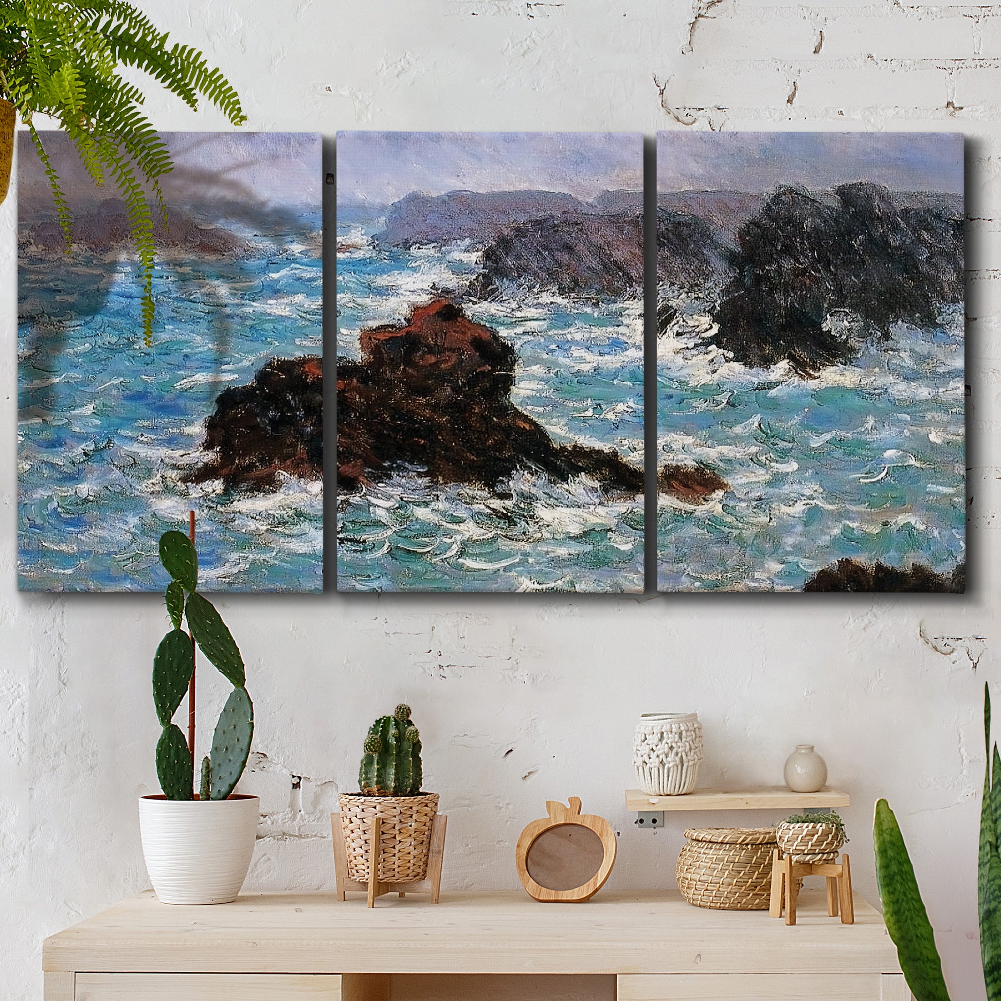 Three-panel canvas wall art featuring storm waves battering rocky coast, displayed in a boho-chic entryway above a console table.
