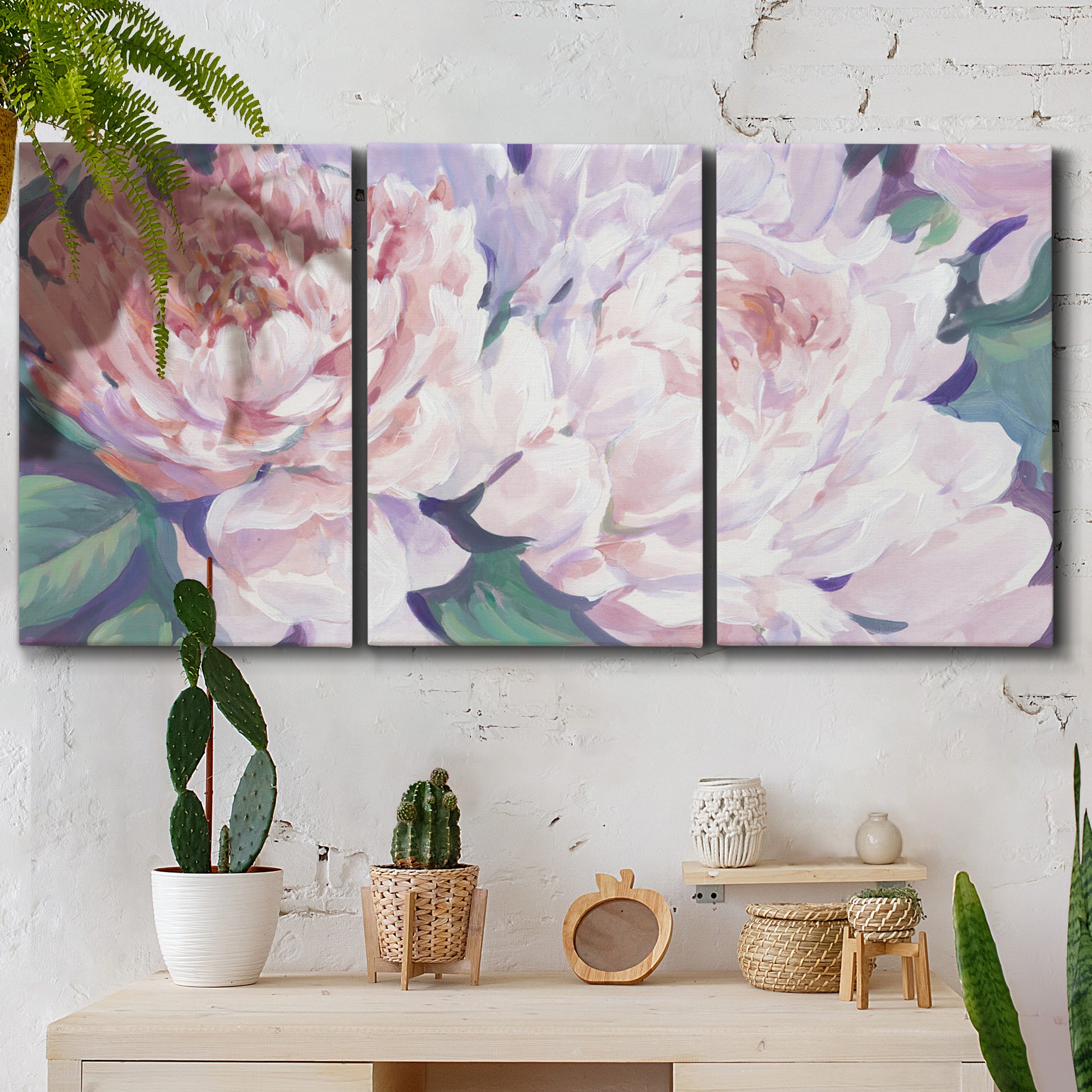 Three-panel canvas wall art featuring soft pink peonies in bloom, displayed in a boho-chic entryway above a console table.