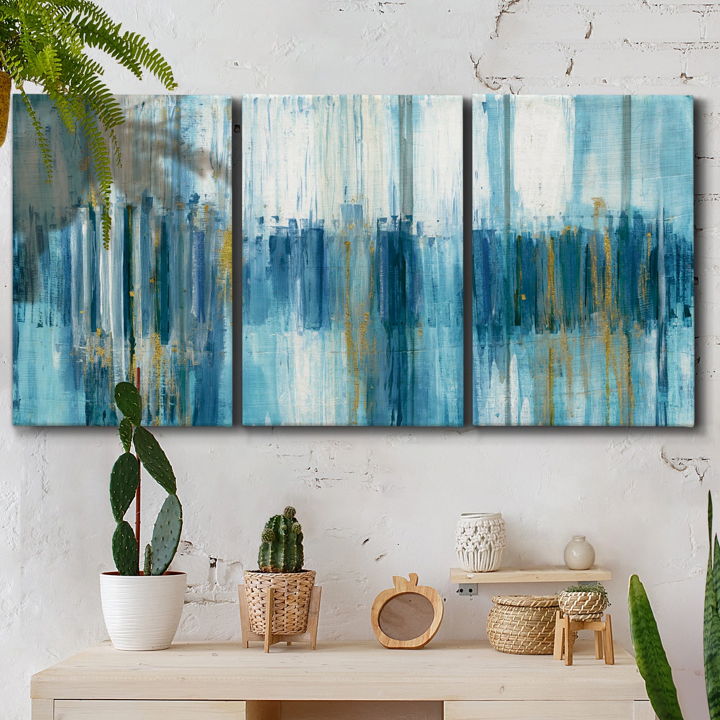 Three-panel canvas wall art featuring layered abstract earth tones, displayed in a boho-chic entryway above a console table.