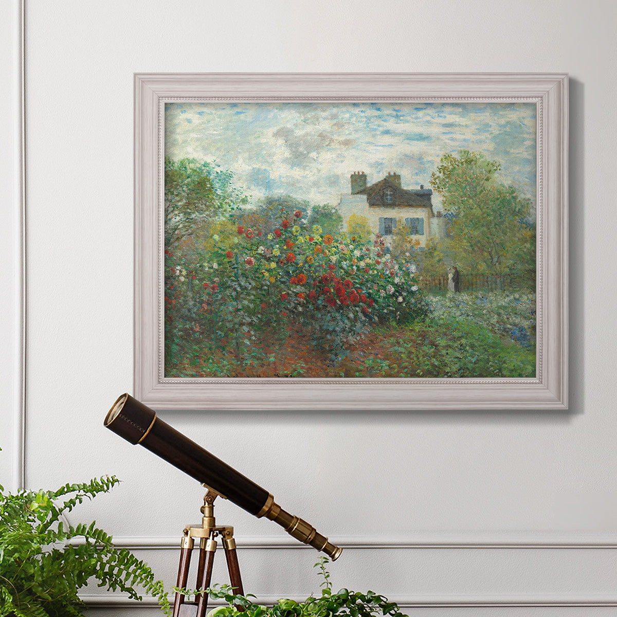Impressionist garden landscape at Argenteuil by Claude Monet in an ornate weathered white frame displayed in a light-toned interior setting.