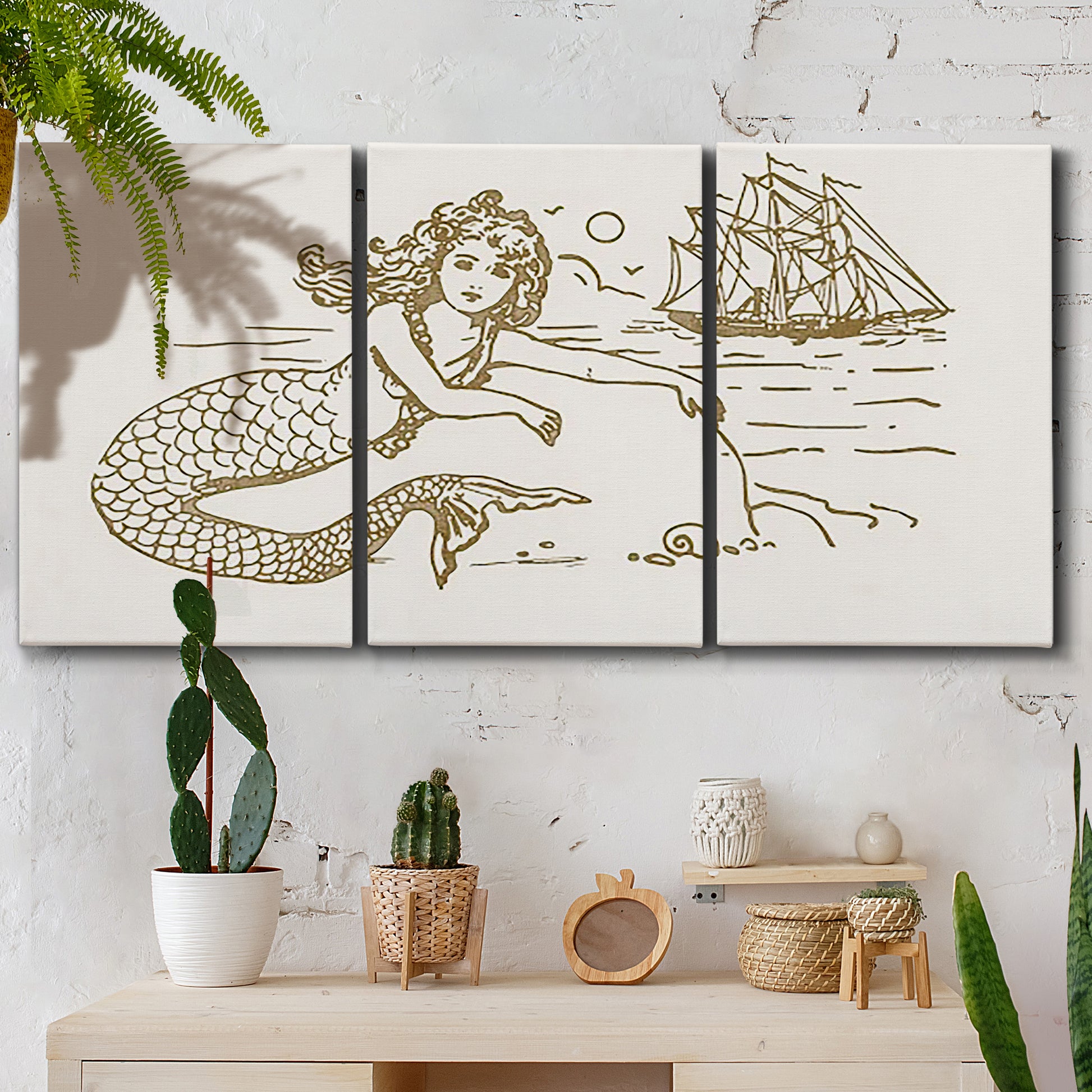 Three-panel canvas wall art featuring whimsical mermaid resting by sea, displayed in a boho-chic entryway above a console table.