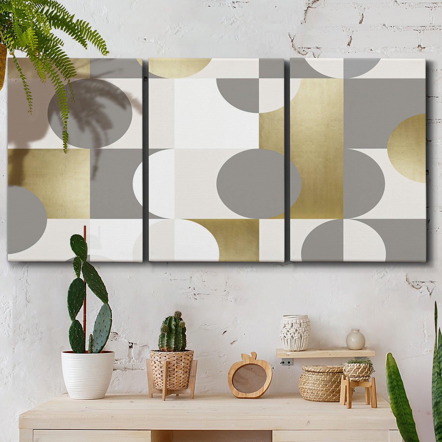 Three-panel canvas wall art featuring geometric gold abstract reflections, displayed in a boho-chic entryway above a console table.