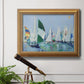 Coastal harbor watercolor painting in an ornate antique gold frame displayed in a light-toned interior setting.