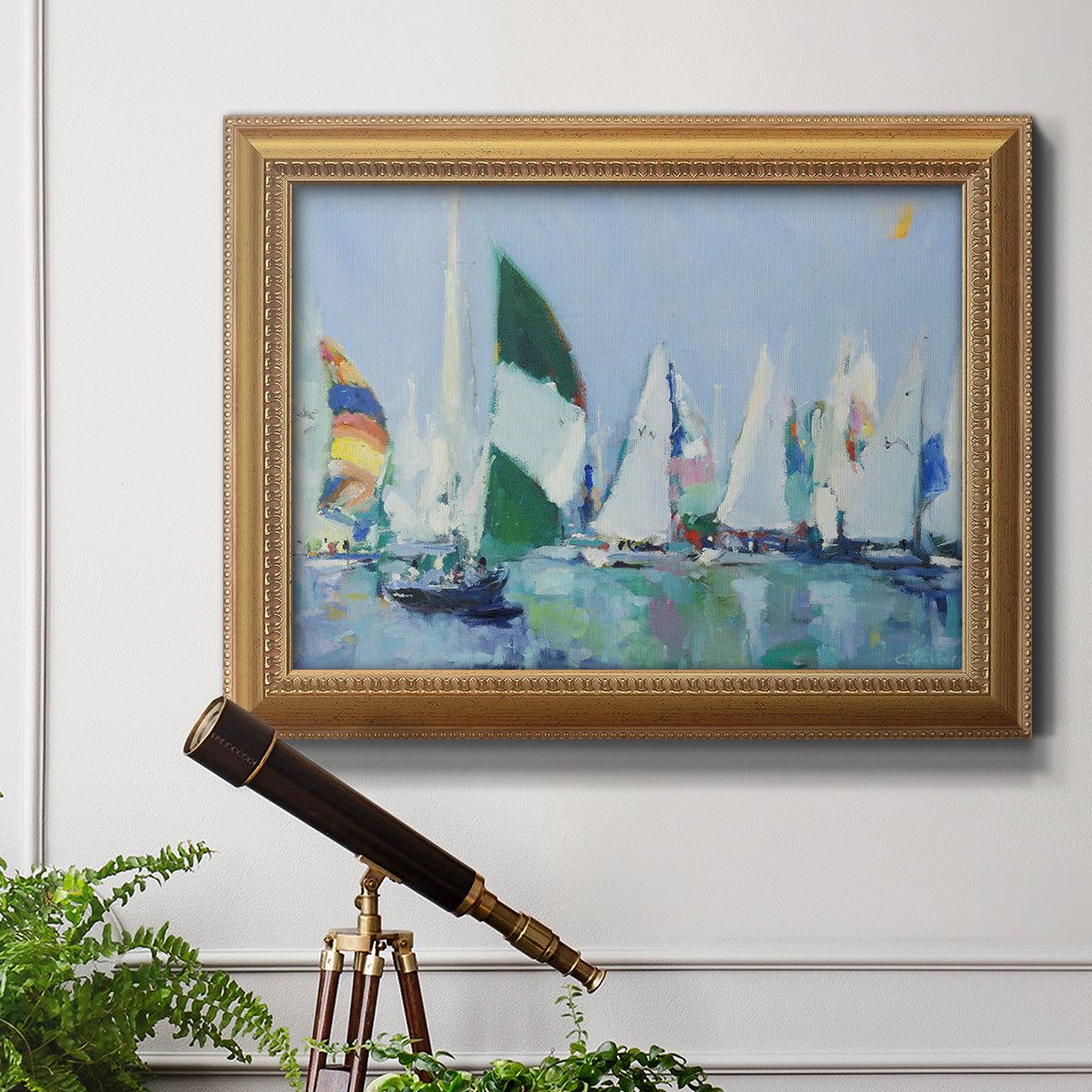 Coastal harbor watercolor painting in an ornate antique gold frame displayed in a light-toned interior setting.