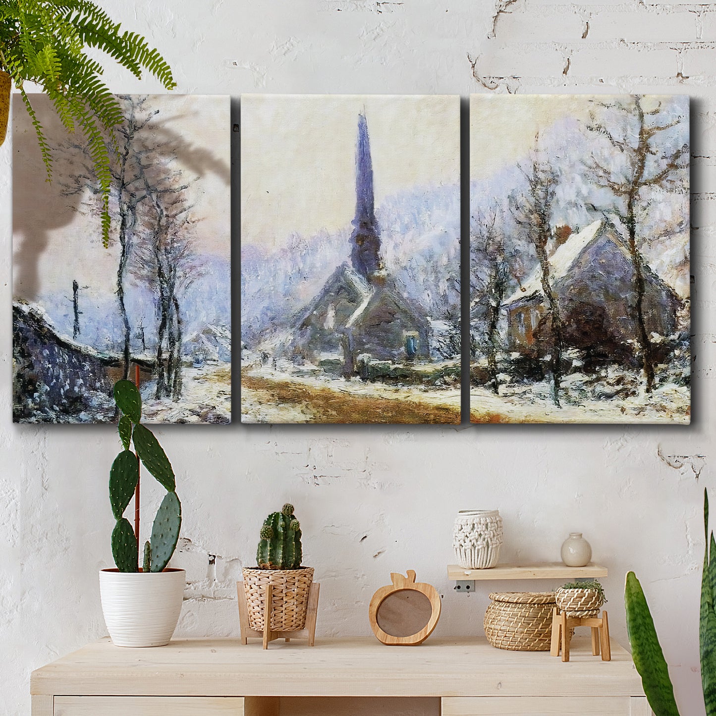 Three-panel canvas wall art featuring snow covered road leading to village, displayed in a boho-chic entryway above a console table.