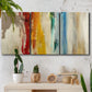 Three-panel canvas wall art featuring abstract divided color hemisphere forms, displayed in a boho-chic entryway above a console table.