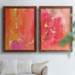 Set of two maple barnwood framed canvas prints depicting translucent warm washes, drips, and scattered metallic accents arranged across two complementary compositions above a sofa in a bright living space.