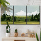 Three-panel canvas wall art featuring lush green summer countryside, displayed in a boho-chic entryway above a console table.