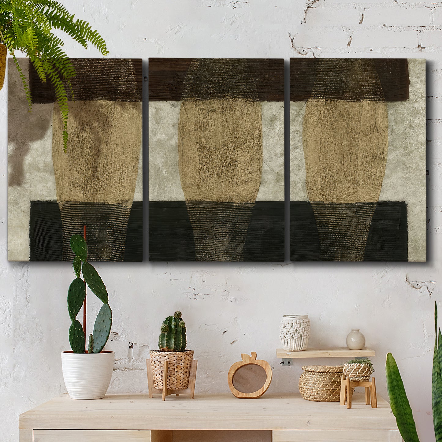Three-panel canvas wall art featuring textured abstract vessel forms, displayed in a boho-chic entryway above a console table.