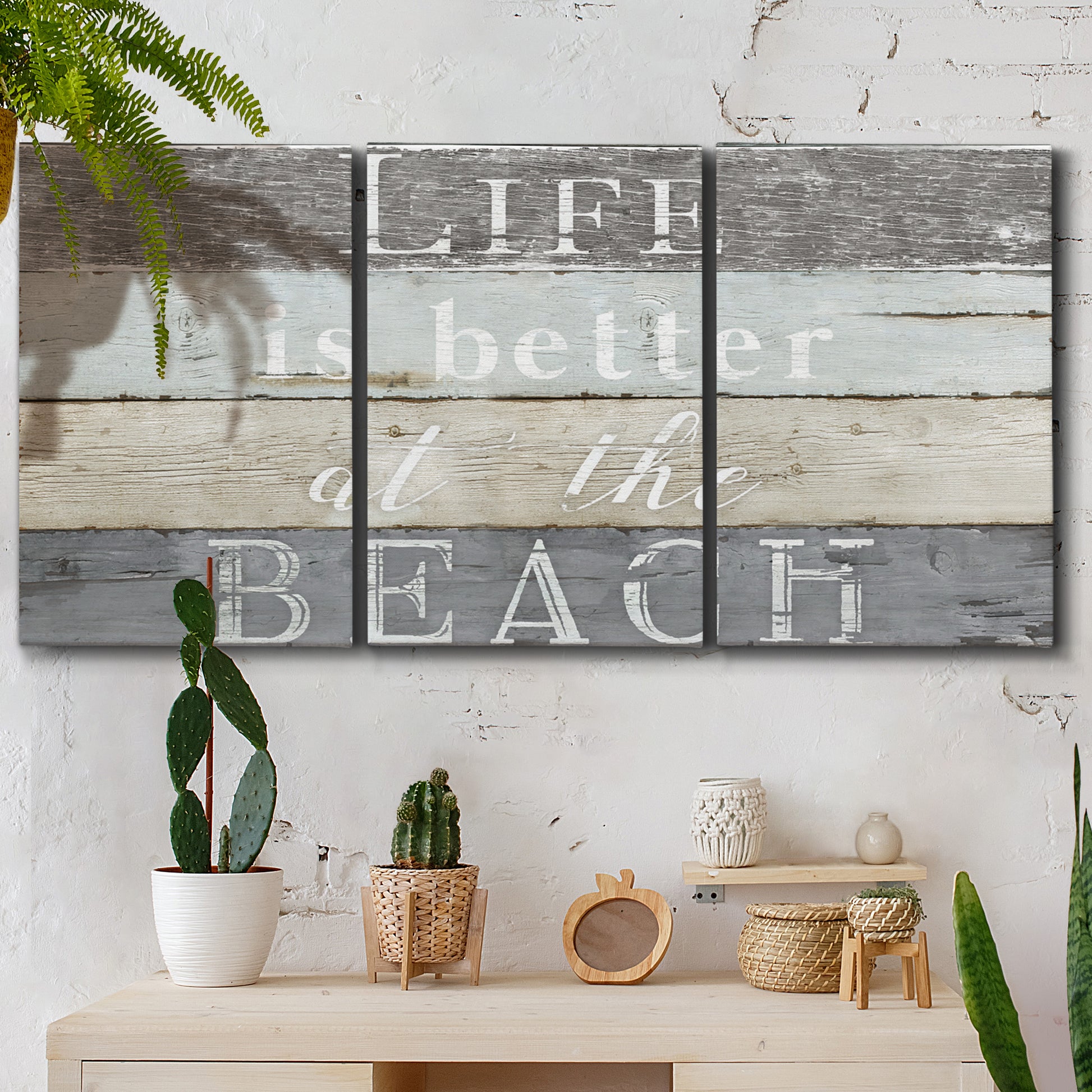 Three-panel canvas wall art featuring beach themed typography design, displayed in a boho-chic entryway above a console table.