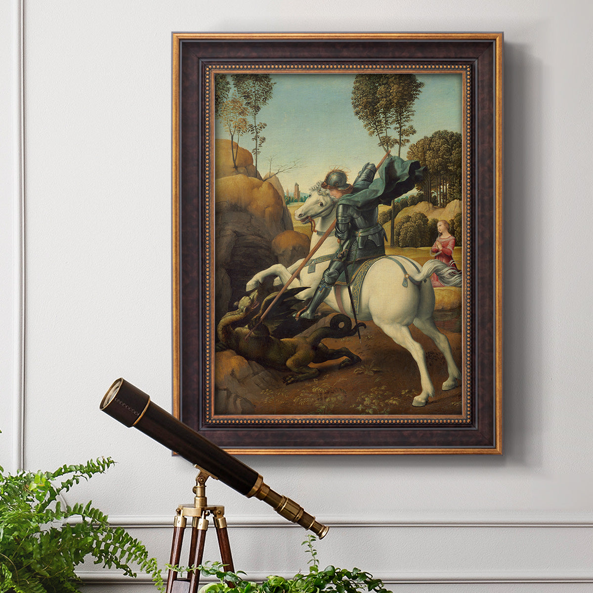 Religious painting of Saint George slaying the dragon by Raphael in an ornate bronzed mahogany wood frame displayed in a light-toned interior setting.