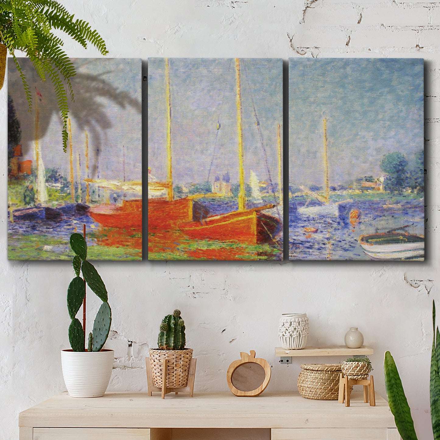 Three-panel canvas wall art featuring red boats along riverbank, displayed in a boho-chic entryway above a console table.