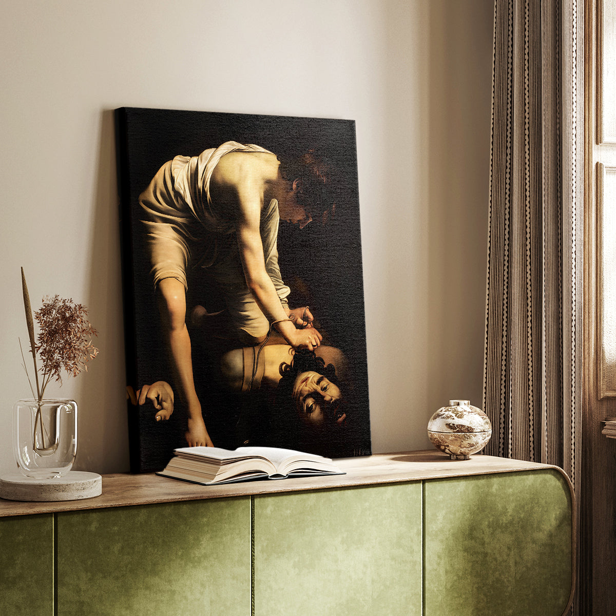 Canvas art print of a figure holding a severed head with strong light and dark tones styled in a home decor setting.