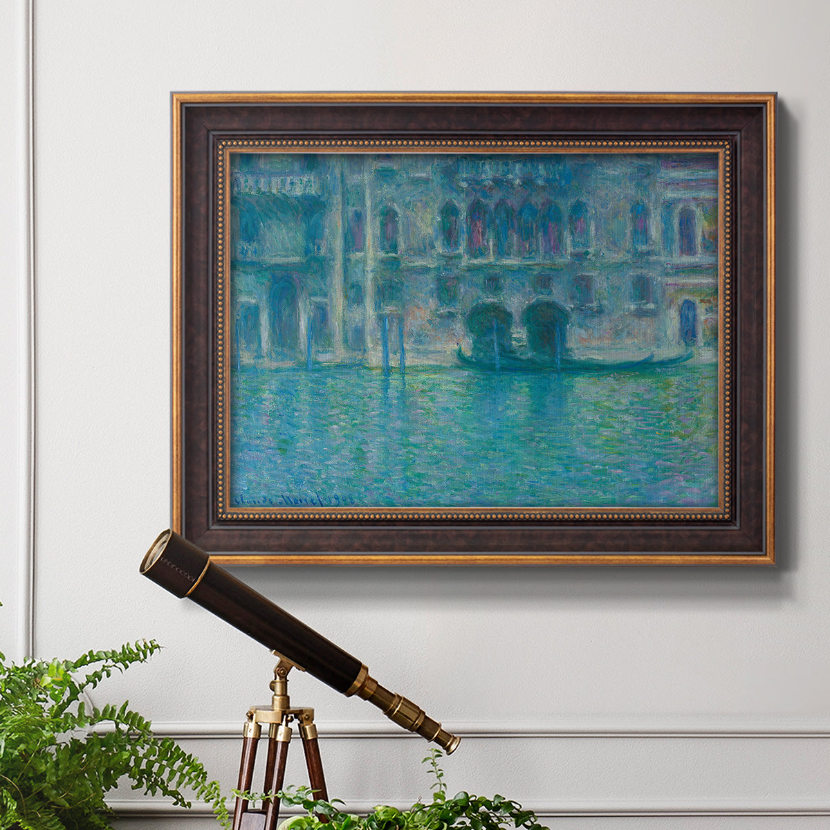 Impressionist Venetian palace waterfront scene by Claude Monet in an ornate bronzed mahogany wood frame displayed in a light-toned interior setting.