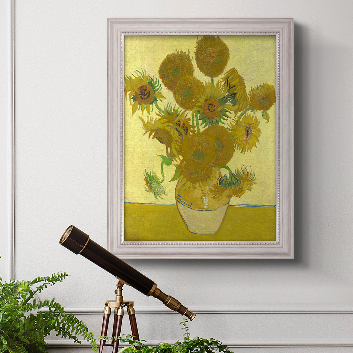 Impressionist sunflower still life painting by Vincent van Gogh in an ornate weathered white frame displayed in a light-toned interior setting.