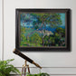 Impressionist Mediterranean coastal landscape by Claude Monet in an ornate black frame with gilded inner detail displayed in a light-toned interior setting.