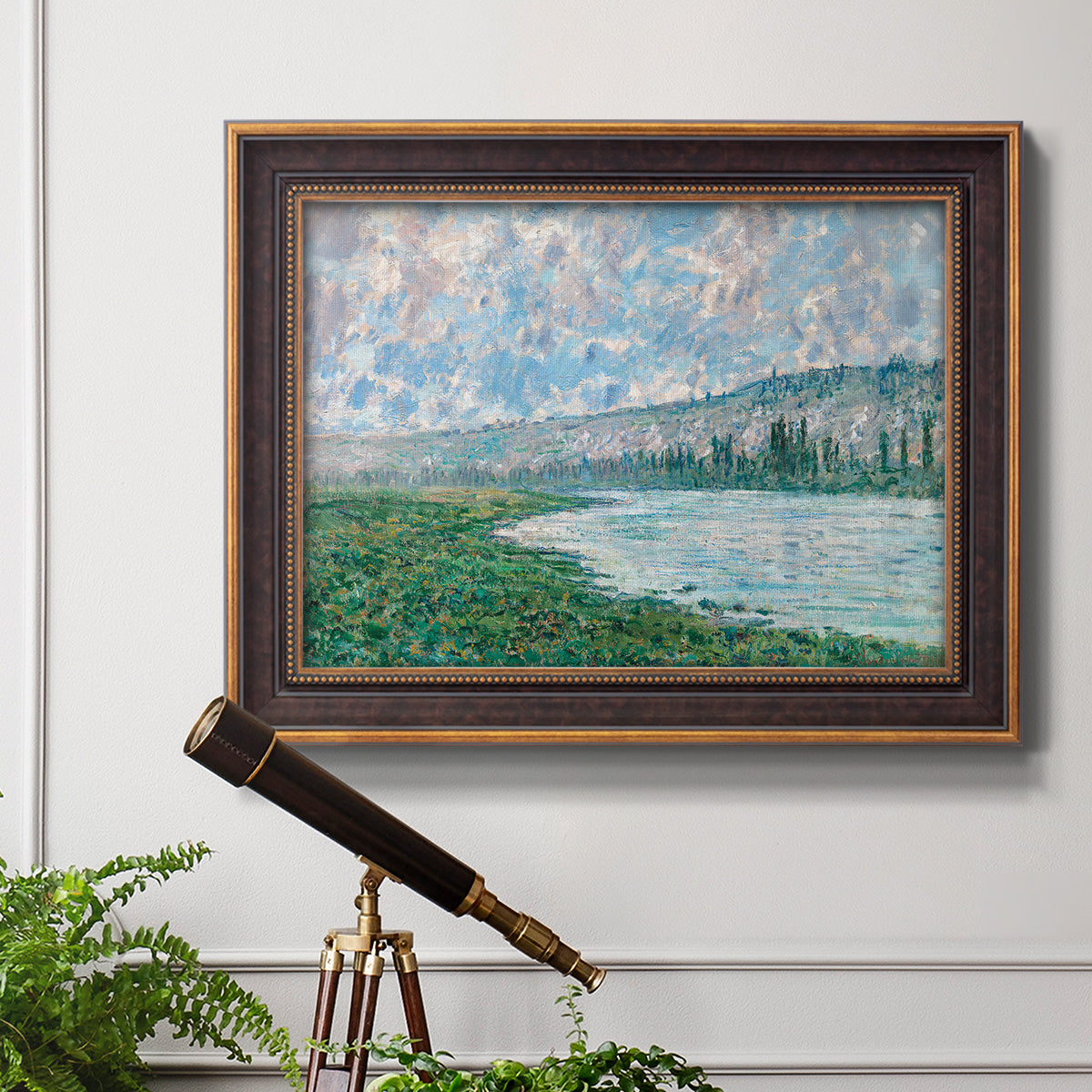 Impressionist river landscape at Vétheuil by Claude Monet in an ornate bronzed mahogany wood frame displayed in a light-toned interior setting.