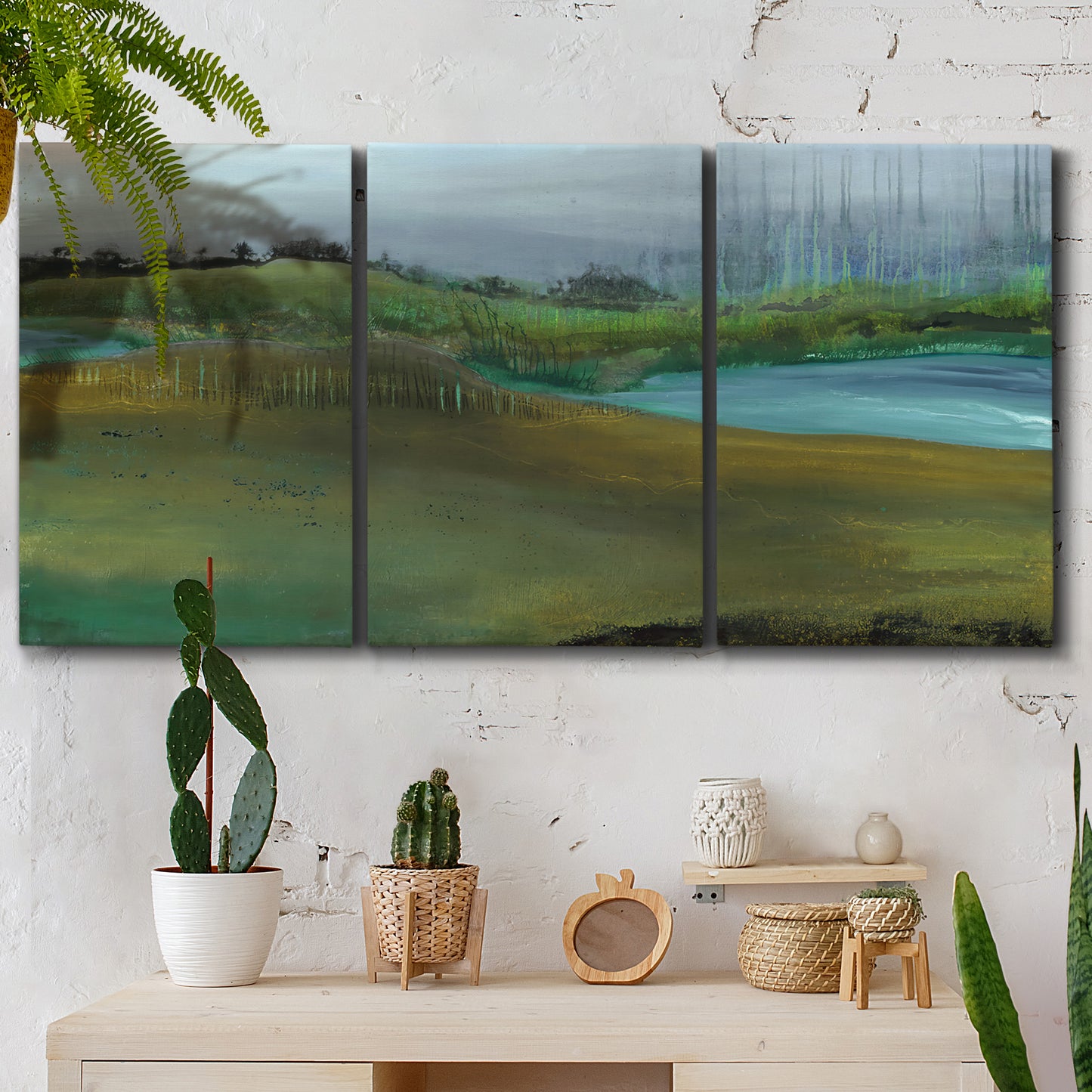 Three-panel canvas wall art featuring quiet contemplative landscape scene, displayed in a boho-chic entryway above a console table.