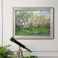 Impressionist spring orchard landscape by Vincent van Gogh in an ornate champagne frame displayed in a light-toned interior setting.