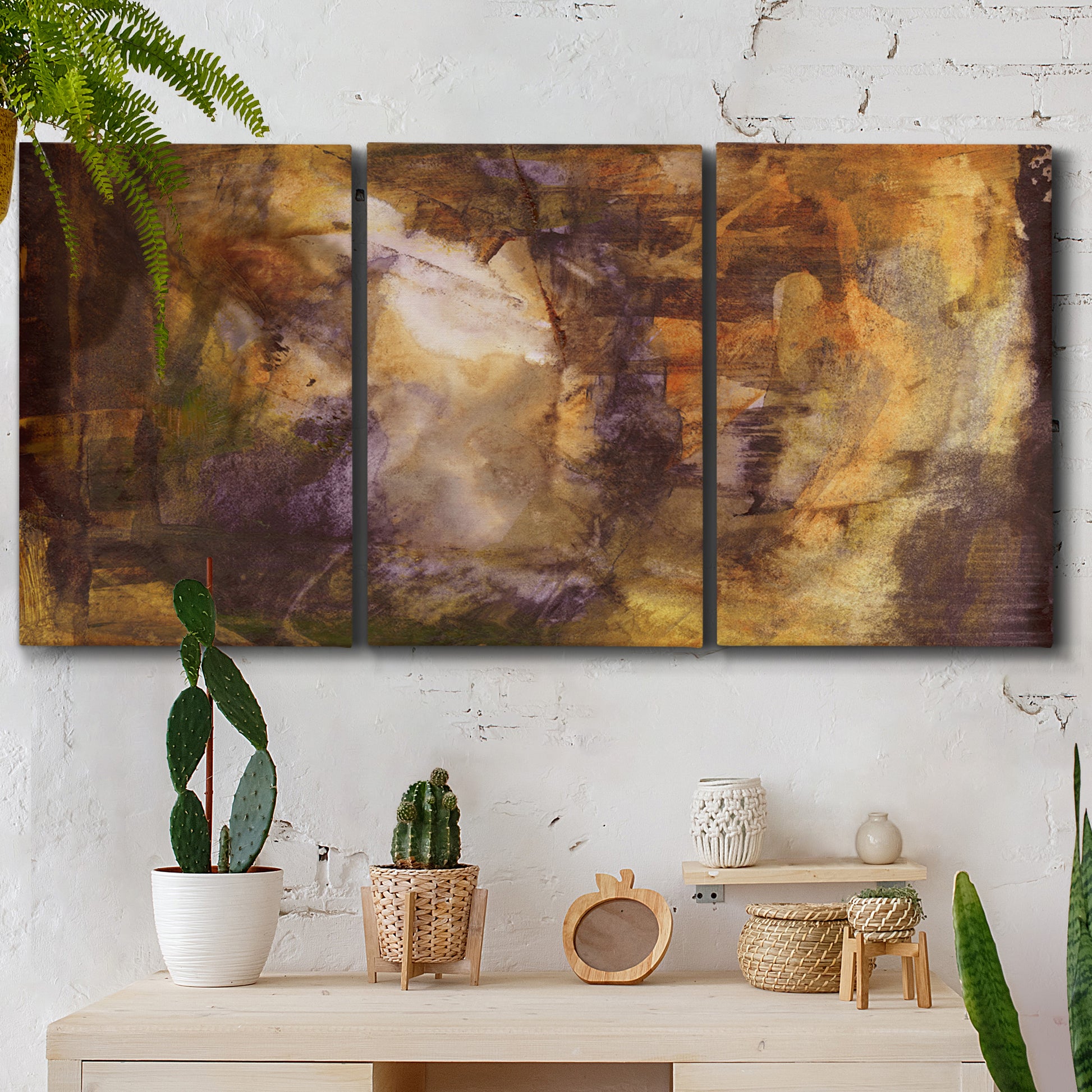 Three-panel canvas wall art featuring abstract architectural landscape, displayed in a boho-chic entryway above a console table.