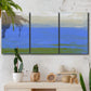 Three-panel canvas wall art featuring abstract coastal inlet landscape, displayed in a boho-chic entryway above a console table.