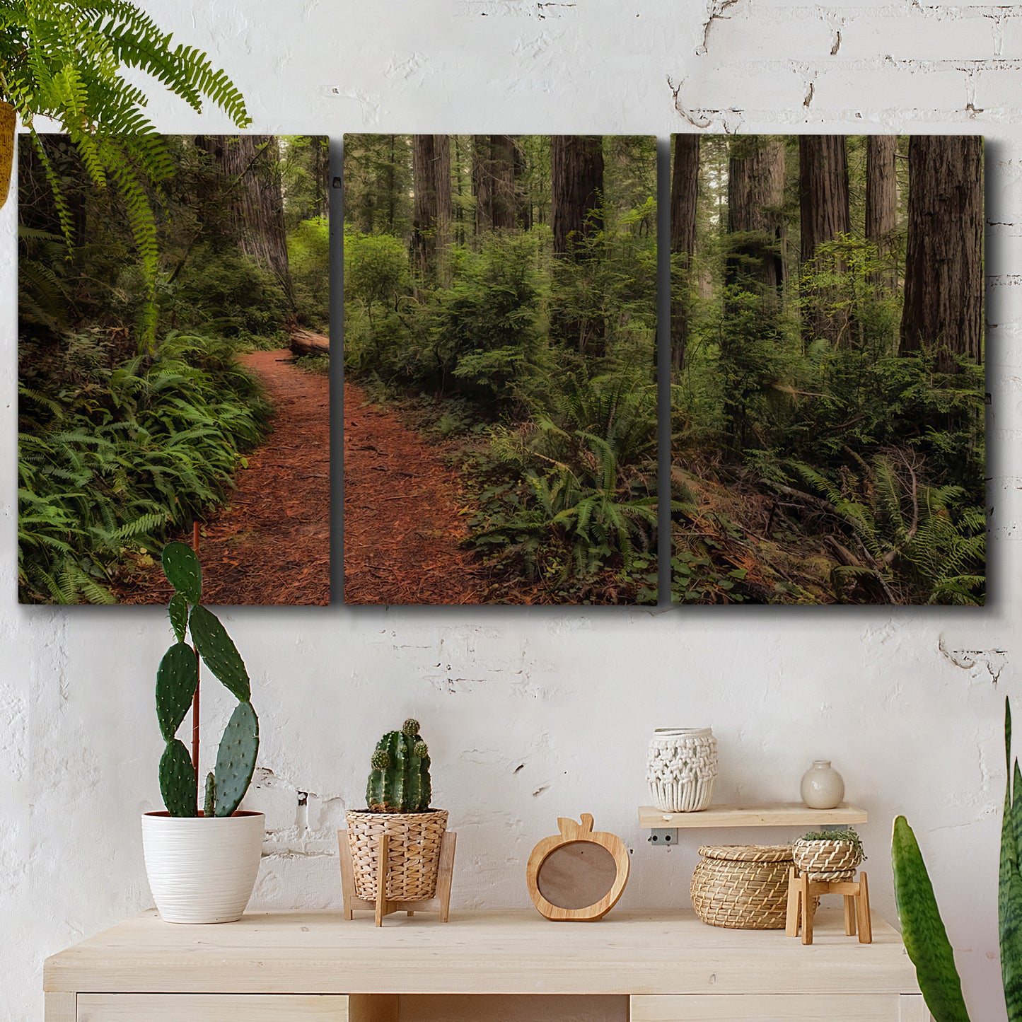 Three-panel canvas wall art featuring forest trail landscape photograph, displayed in a boho-chic entryway above a console table.