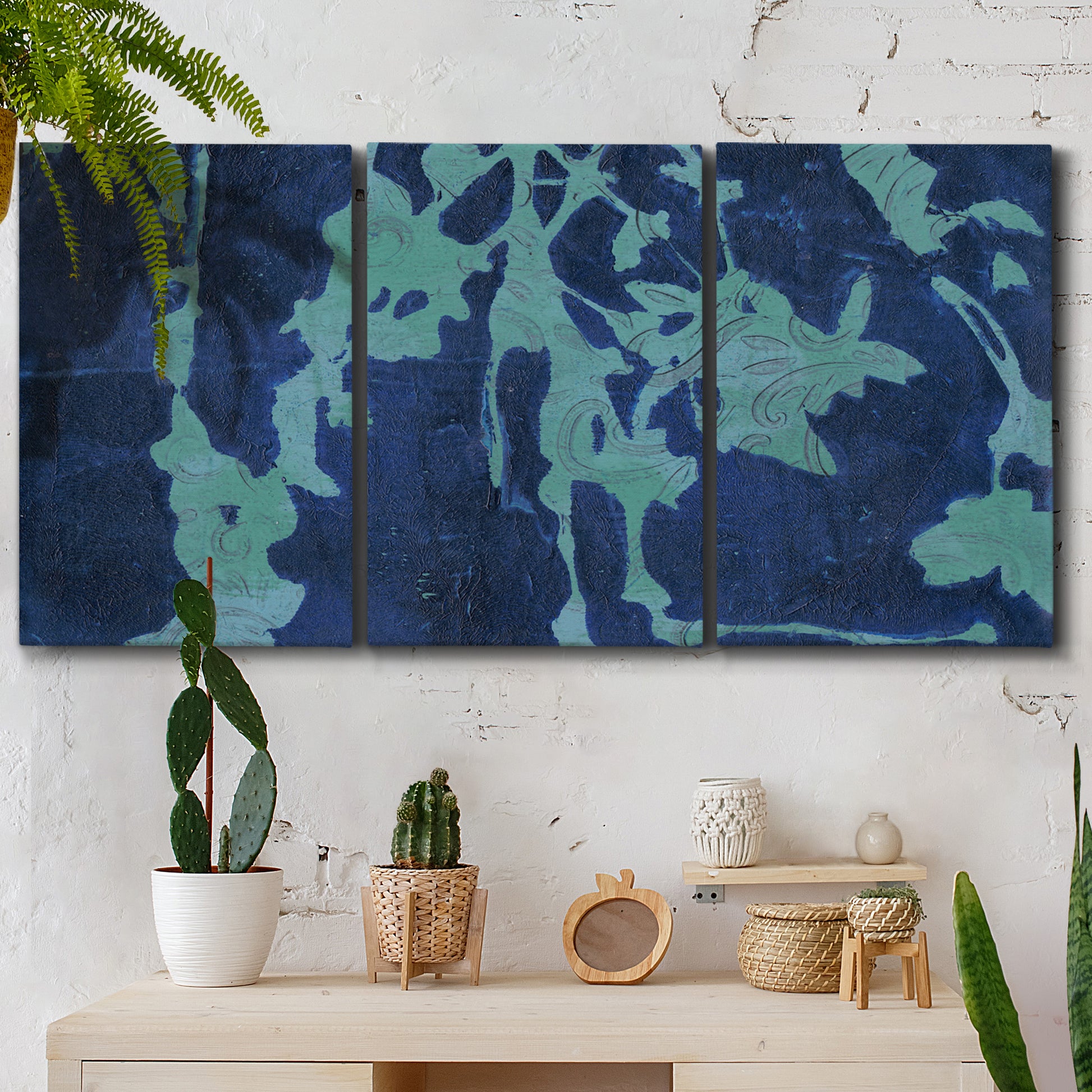 Three-panel canvas wall art featuring abstract floral shapes, displayed in a boho-chic entryway above a console table.
