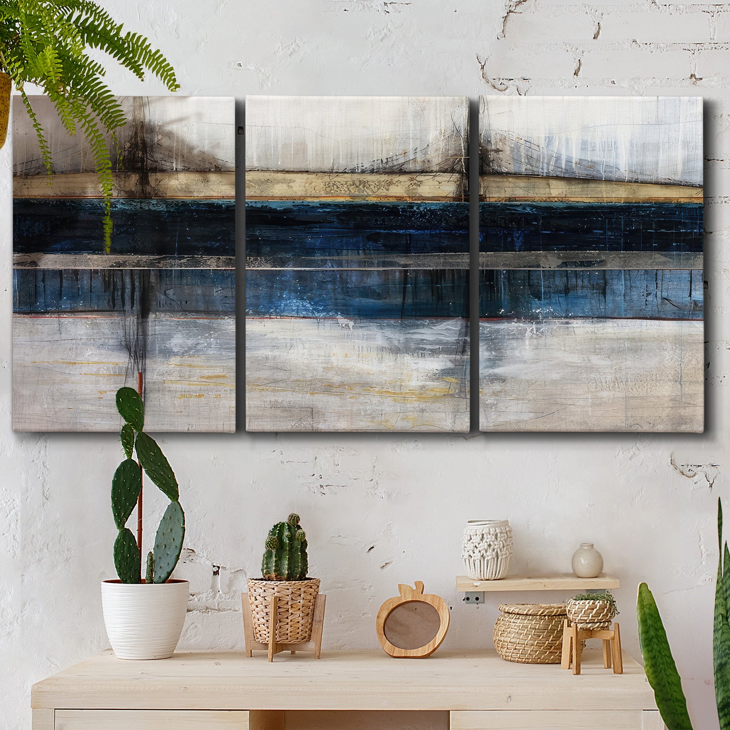 Three-panel canvas wall art featuring abstract blue urban composition, displayed in a boho-chic entryway above a console table.