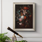 Classical floral still life painting by Jan van Huysum in an ornate champagne frame displayed in a light-toned interior setting.