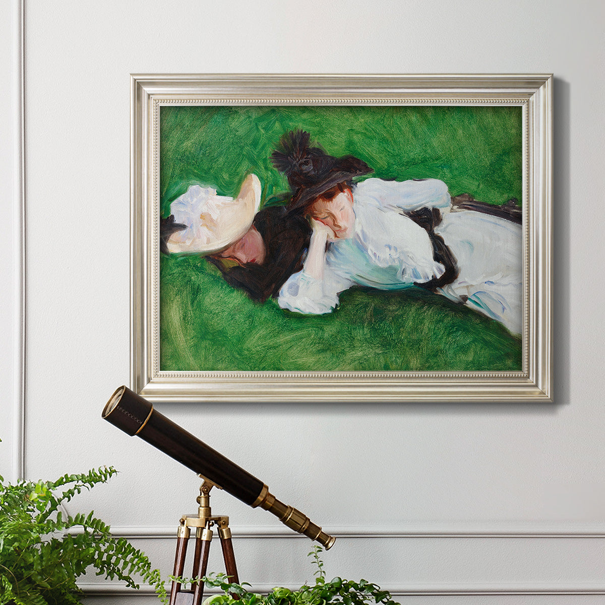 Impressionist outdoor portrait of two girls by John Singer Sargent in an ornate champagne frame displayed in a light-toned interior setting.