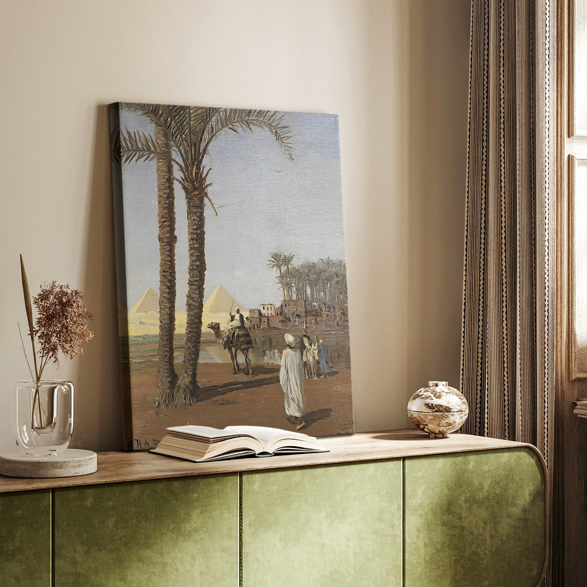 Canvas art print of a distant view of pyramids with figures in a sandy setting styled in a home decor setting.