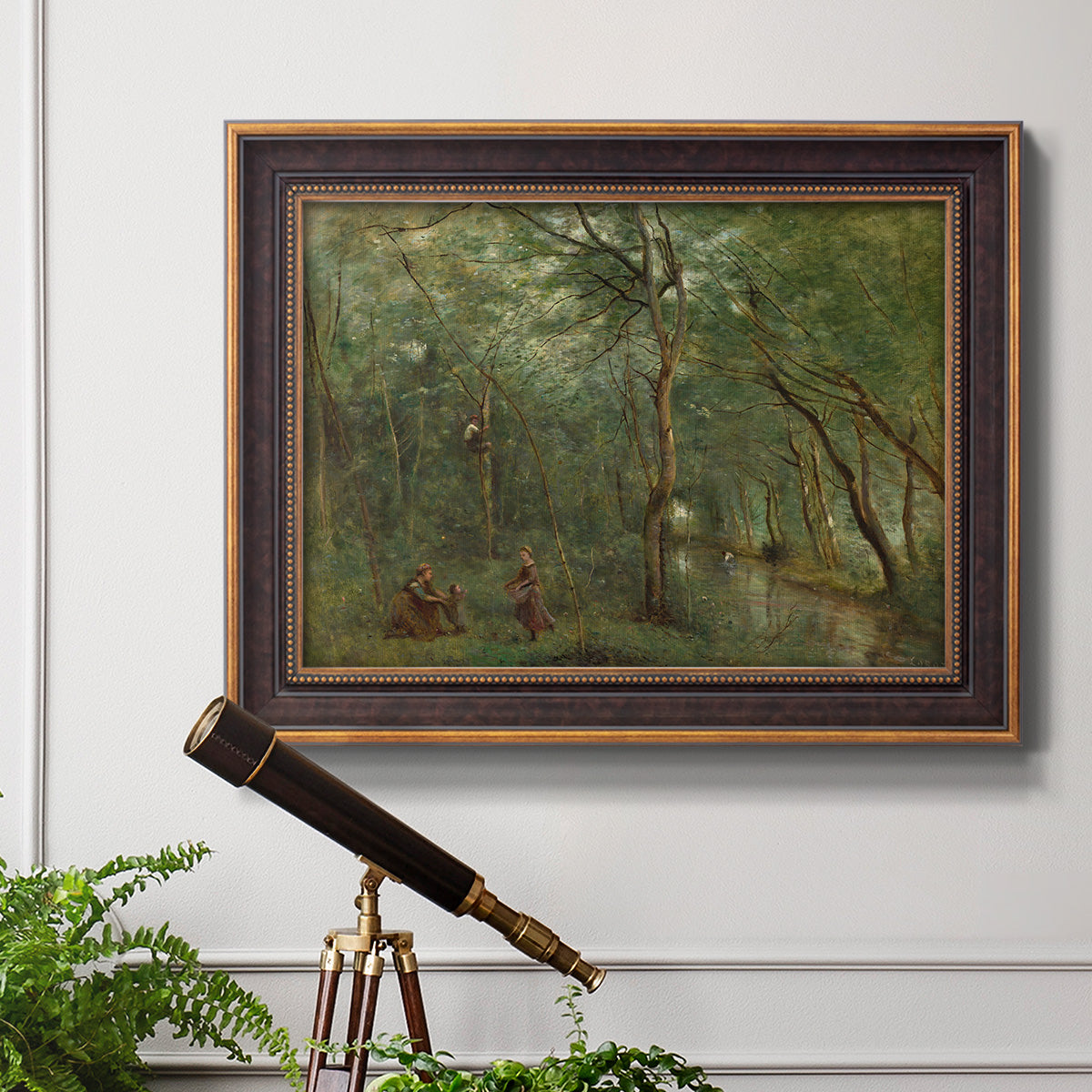 Traditional rural landscape scene with figures by Jean-Baptiste-Camille Corot in an ornate bronzed mahogany wood frame displayed in a light-toned interior setting.
