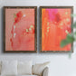 Set of two walnut barnwood framed canvas prints depicting translucent warm washes, drips, and scattered metallic accents arranged across two complementary compositions above a sofa in a bright living space.