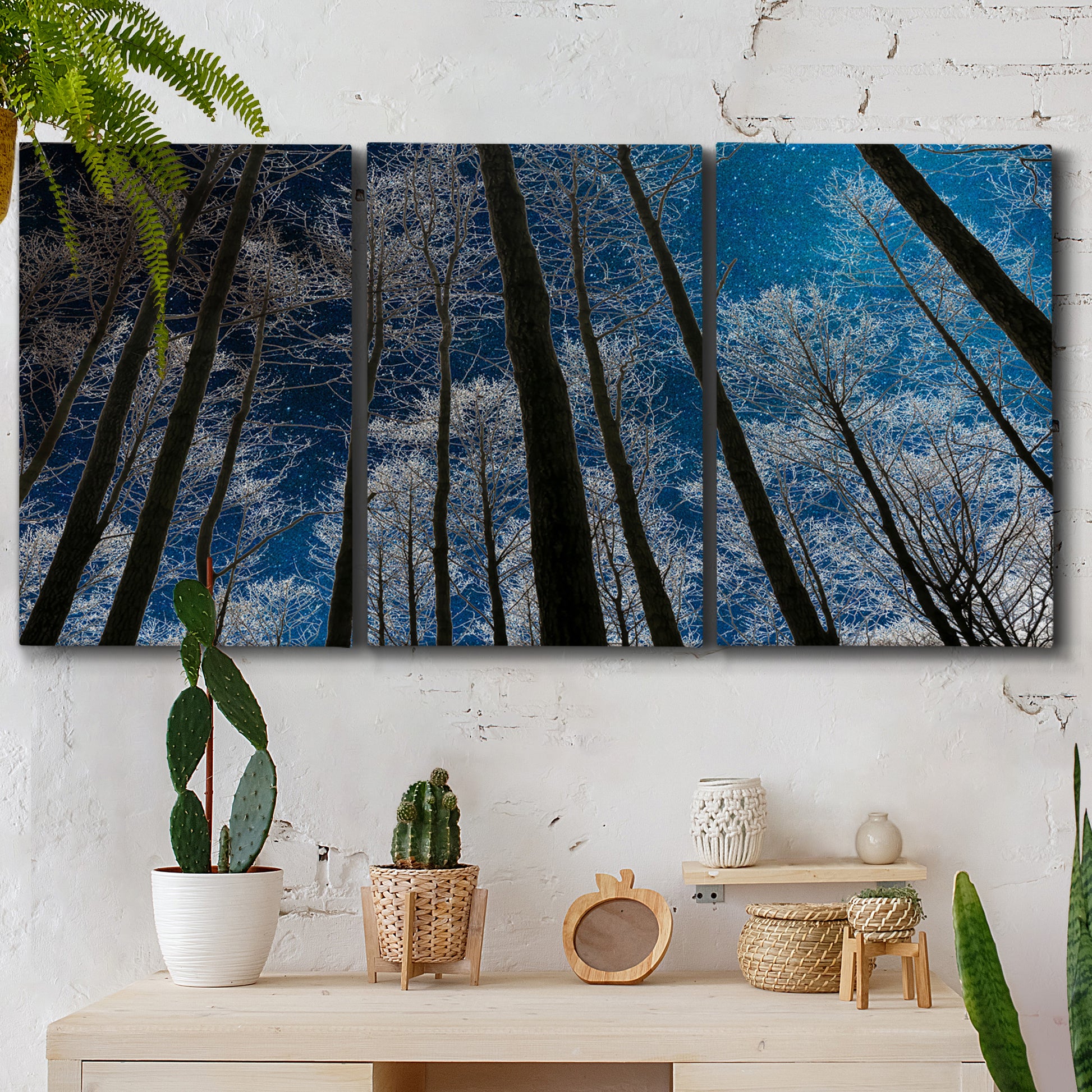 Three-panel canvas wall art featuring night landscape silhouette photography, displayed in a boho-chic entryway above a console table.