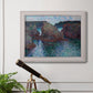 Impressionist rocky seascape by Claude Monet in an ornate weathered white frame displayed in a light-toned interior setting.
