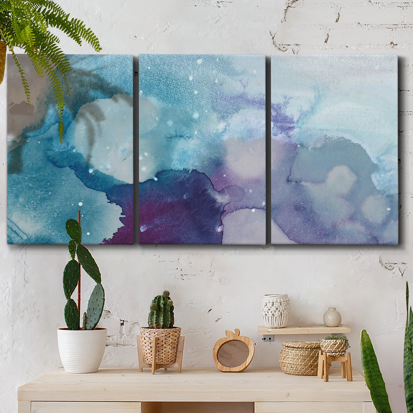 Three-panel canvas wall art featuring icy abstract crystalline forms, displayed in a boho-chic entryway above a console table.