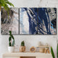 Three-panel canvas wall art featuring layered blue abstract texture, displayed in a boho-chic entryway above a console table.