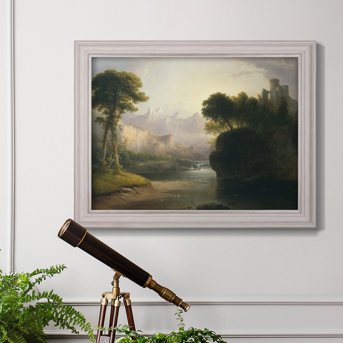 Romantic autumn landscape along the Hudson River by Thomas Doughty in an ornate weathered white frame displayed in a light-toned interior setting.