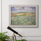 Impressionist countryside landscape near Auvers by Vincent van Gogh in an ornate weathered white frame displayed in a light-toned interior setting.
