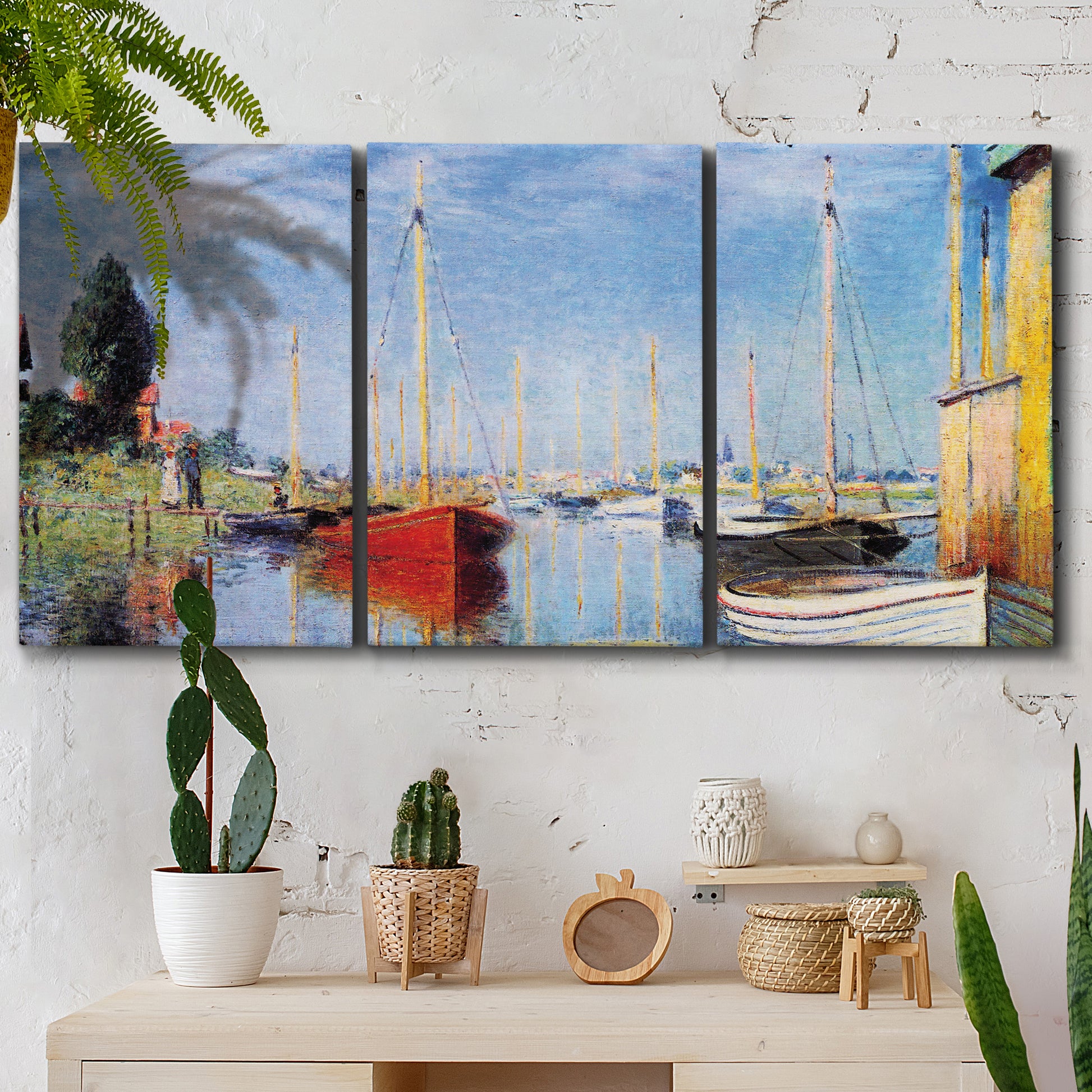 Three-panel canvas wall art featuring sailboats gathered along river, displayed in a boho-chic entryway above a console table.