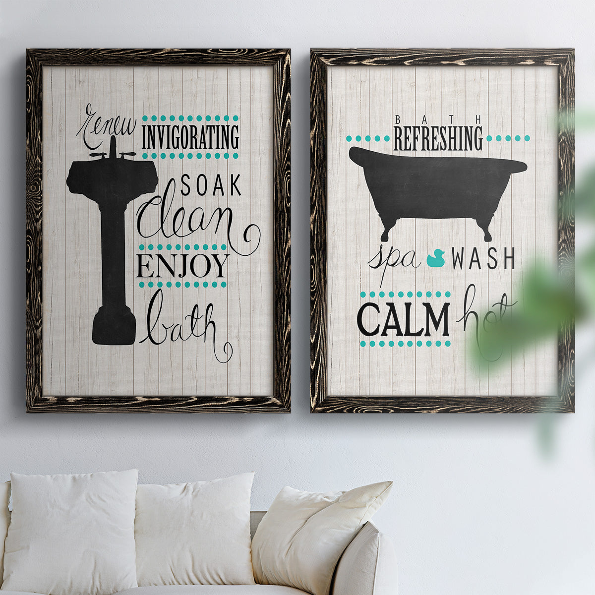 Set of two black barnwood framed canvas prints depicting black tubs, hand-lettered phrases, and small teal accents arranged across two complementary compositions above a sofa in a bright living space.