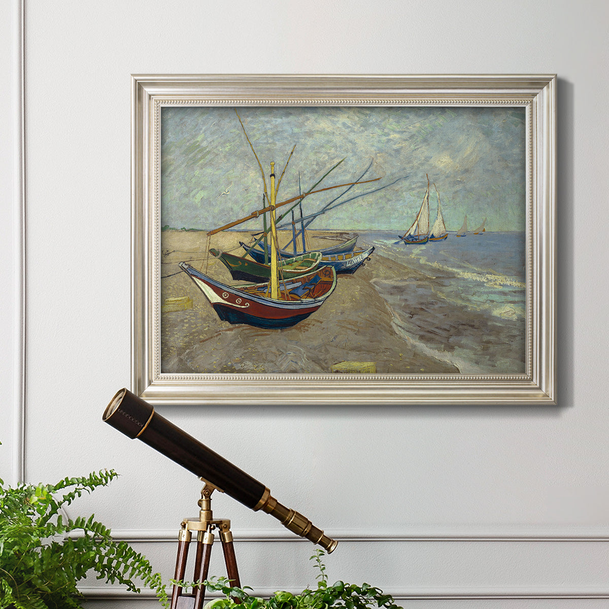 Impressionist coastal fishing boats scene by Vincent van Gogh in an ornate champagne frame displayed in a light-toned interior setting.