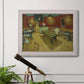 Impressionist interior of a night café by Vincent van Gogh in an ornate weathered white frame displayed in a light-toned interior setting.