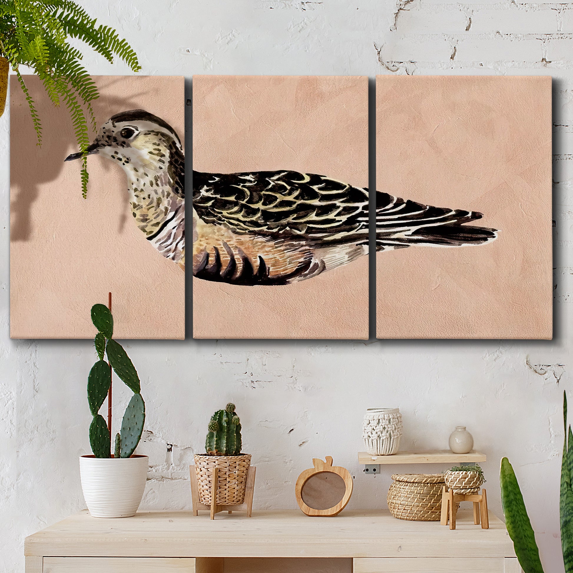 Three-panel canvas wall art featuring coastal bird illustration, displayed in a boho-chic entryway above a console table.