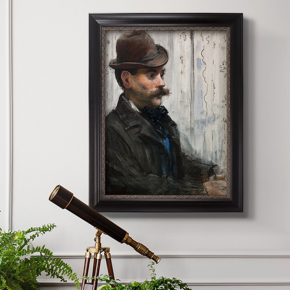 Impressionist portrait of a seated man by Édouard Manet in an ornate black frame with gilded inner detail displayed in a light-toned interior setting.