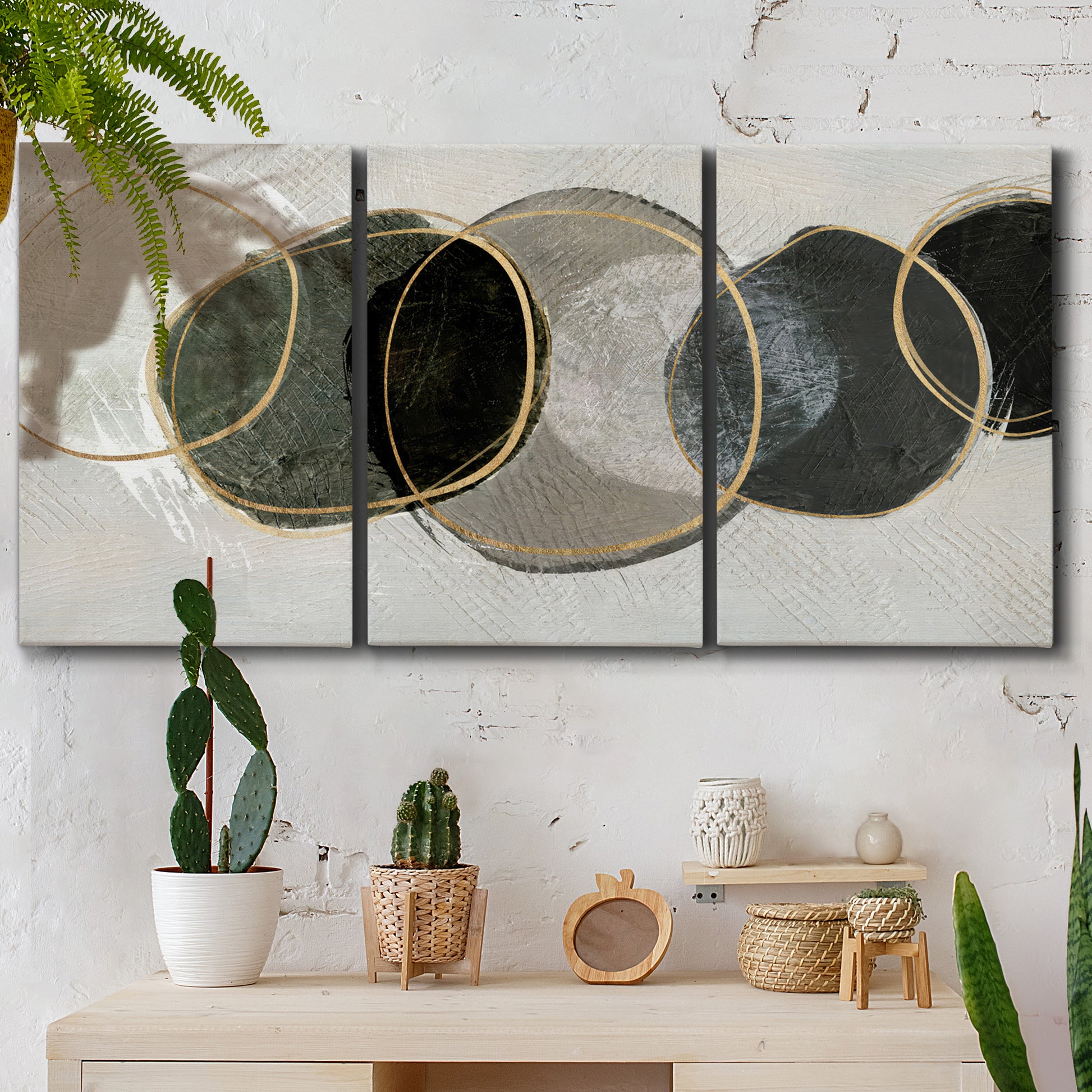 Three-panel canvas wall art featuring smooth abstract river stone forms, displayed in a boho-chic entryway above a console table.